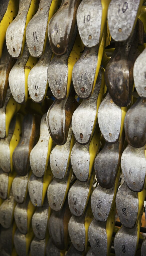 Close up of various metal shoe forms, shoemaker's lasts, in a shoemaker's workshop.